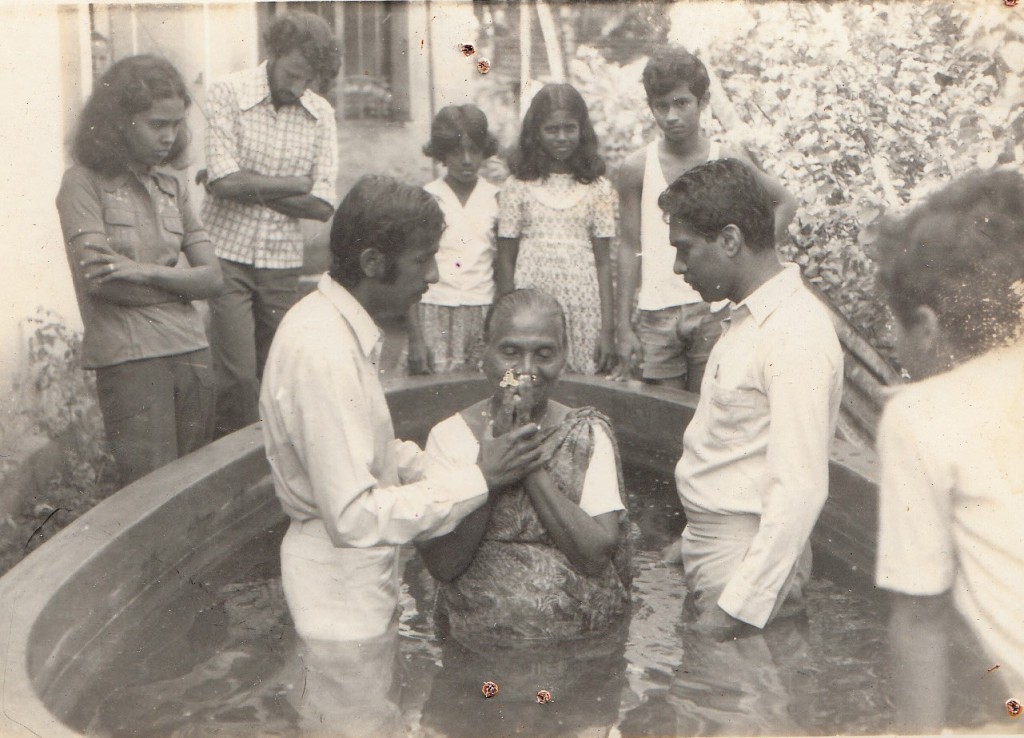 Rev. Susiri holding baptism-1982