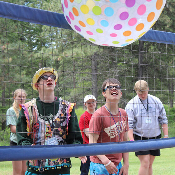 Big_Sky_Volleyball A colorful ball goes over a net as a group of campers play