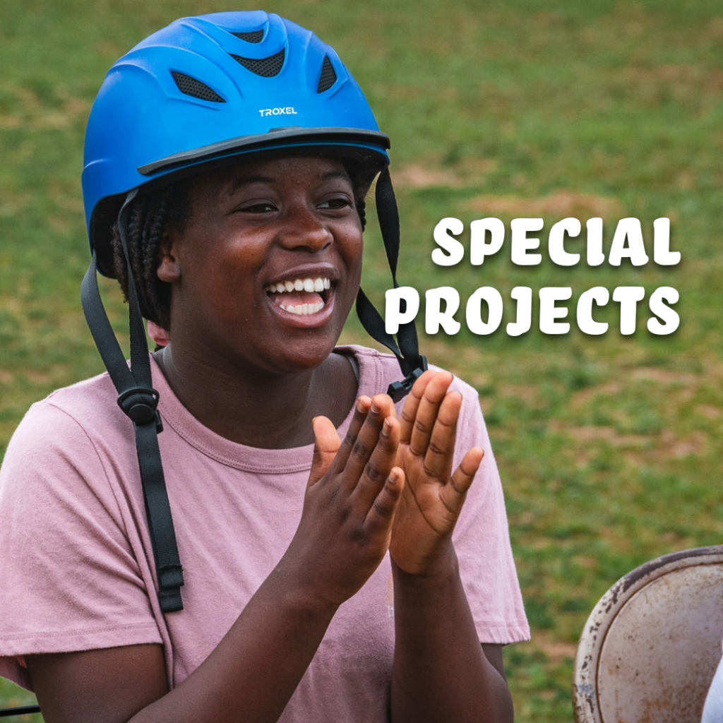 girl in horse riding helmet smiling and clapping