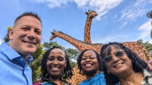 BCM leaders in Africa with giraffe statue in background