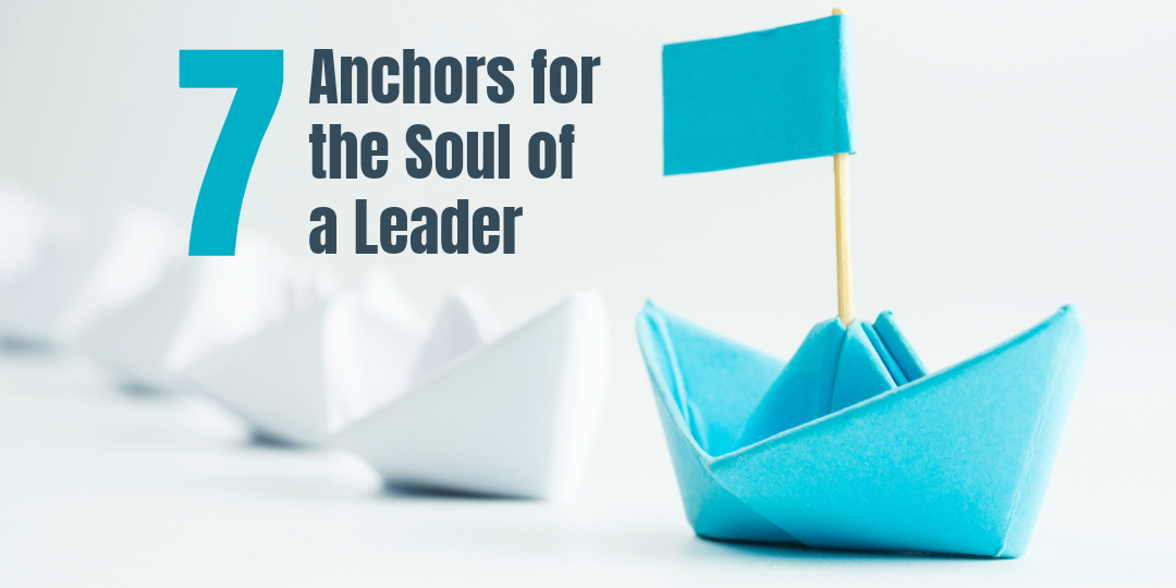 blue paper boat leading other boats 