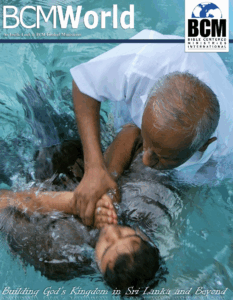 man baptizing person in water