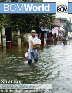 man walking through flood waters