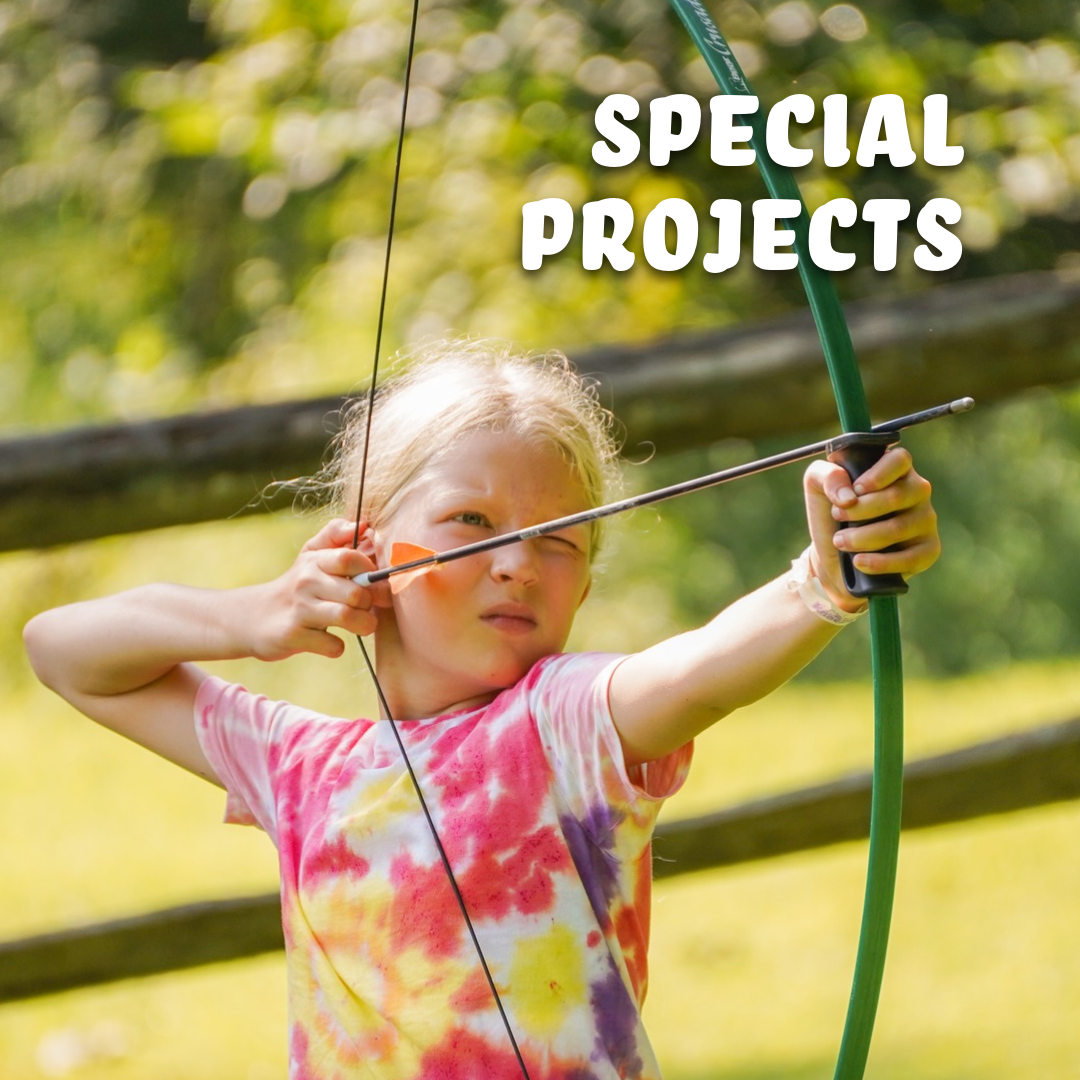 young camper practicing archery